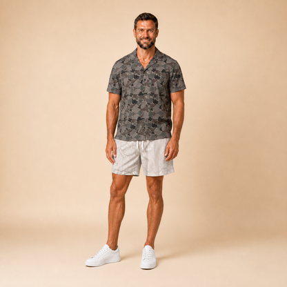 Man wearing Silpaz duck camo sport shorts in cream camo, standing front view