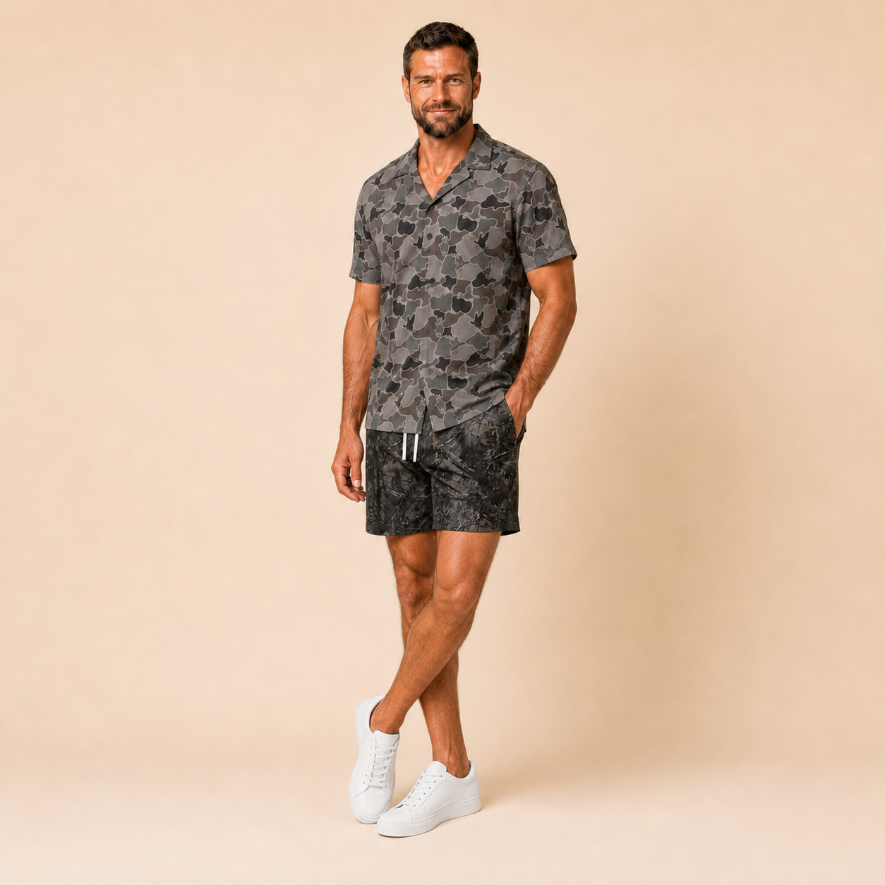 Man wearing Silpaz duck camo sport shorts in black camo, walking pose