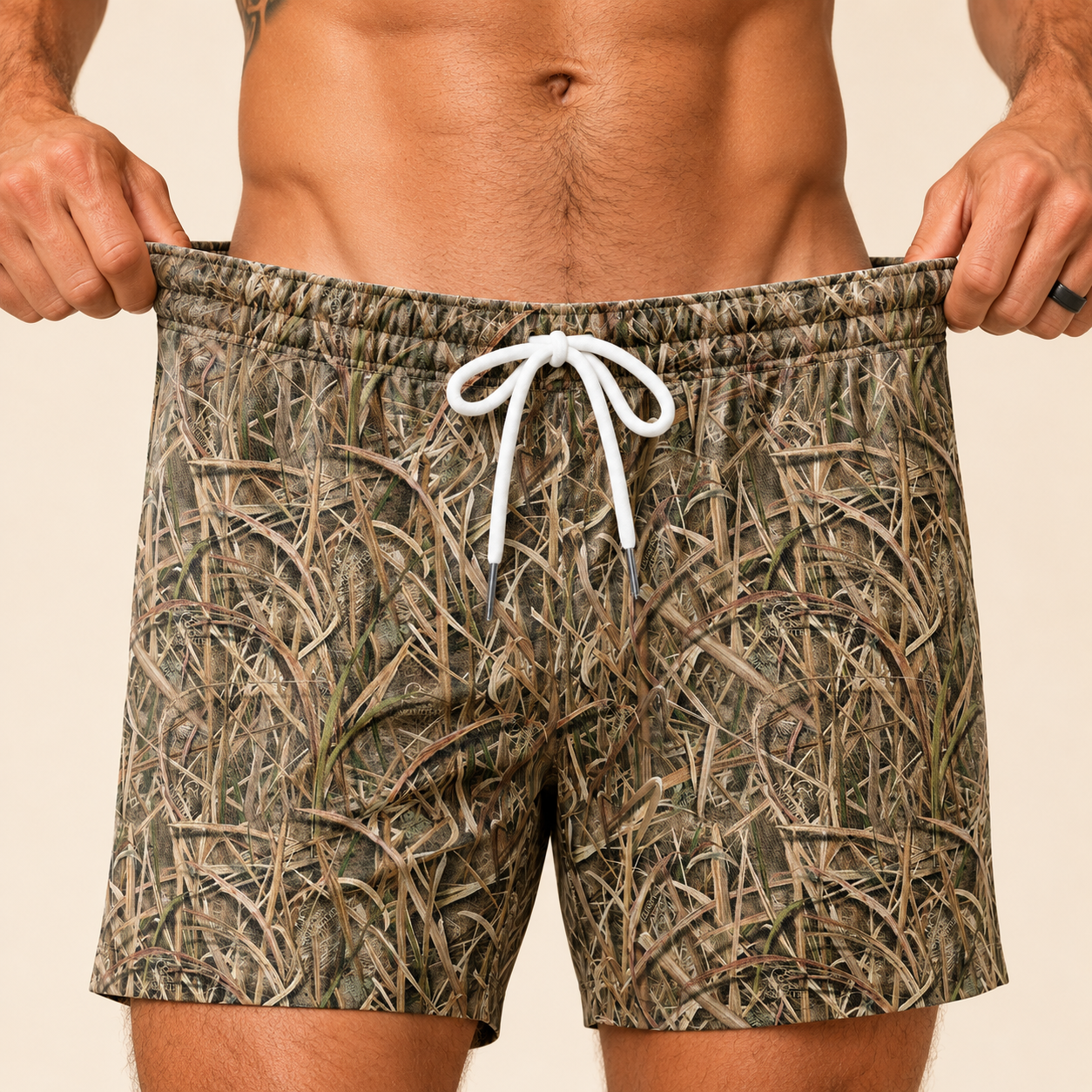 Close-up of Silpaz vintage duck camo shorts in tall grass camo showing the white drawstring waistband