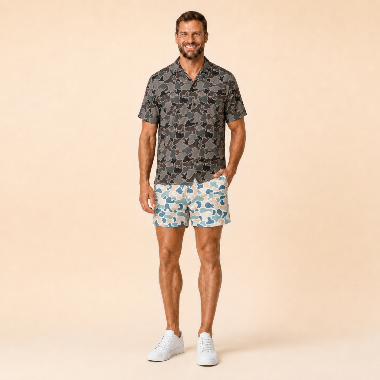 Man wearing Silpaz duck camo athletic shorts in Cream Blue Camo with a dark camp shirt, full length front view
