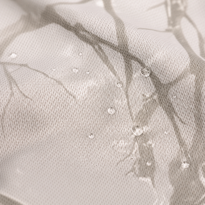 Close-up of tan camo mesh fabric with water droplets beading on the surface