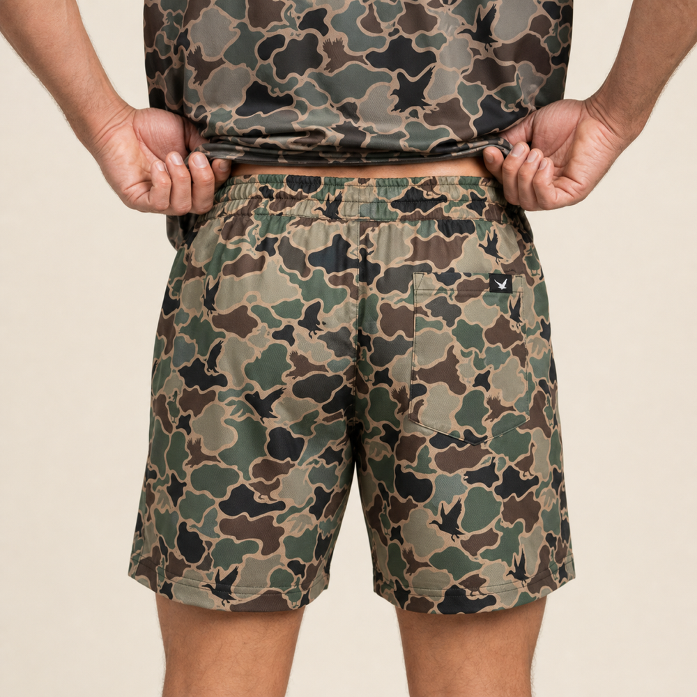 Silpaz Men's Duck Camo Athletic Shorts – Brown Duck Camo — close-up of the back waistband, welt pocket and brand tab