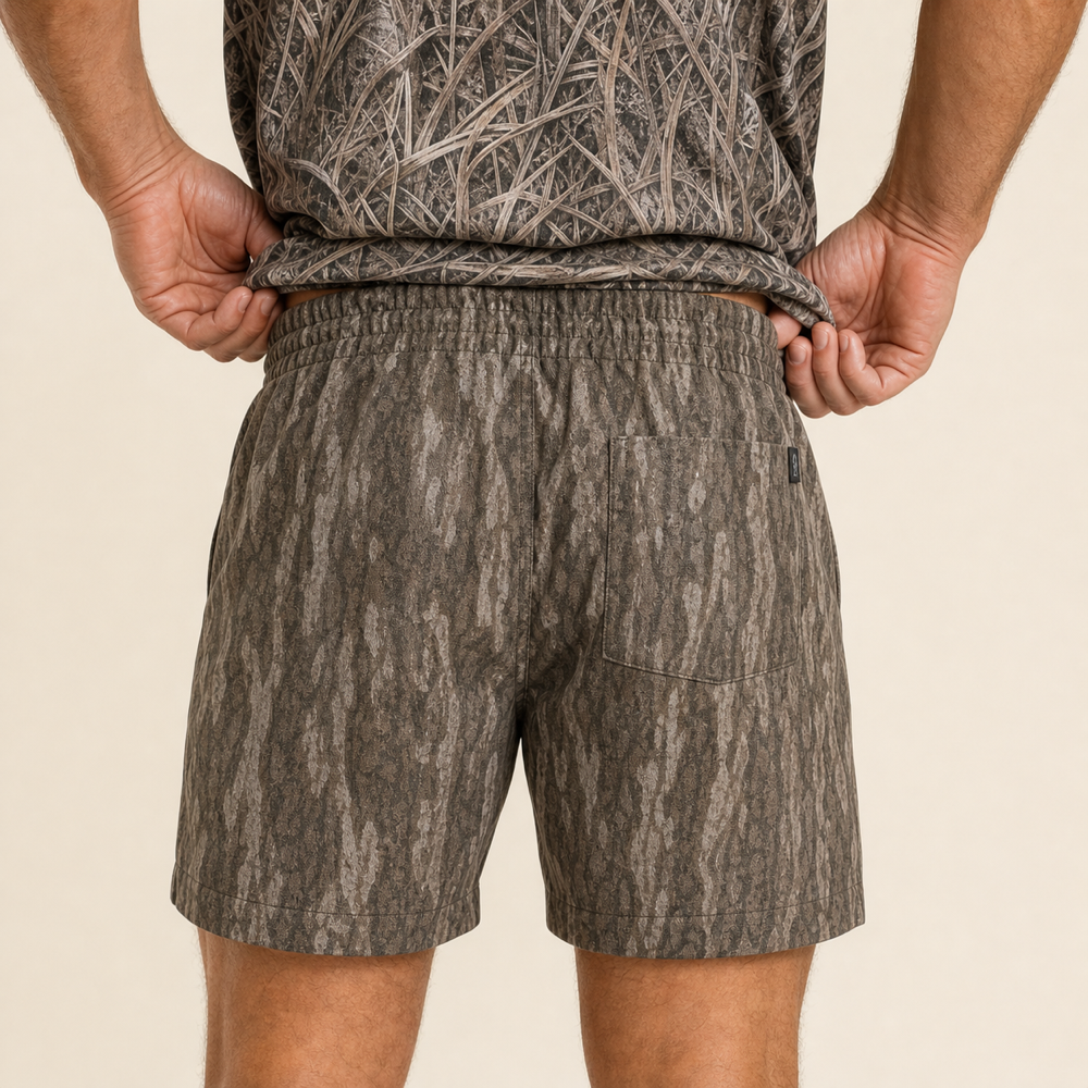 Silpaz Men's Tree Bark Camo Mesh Shorts – Brown Bark Camo — close-up of the back waistband, welt pocket and brand tab