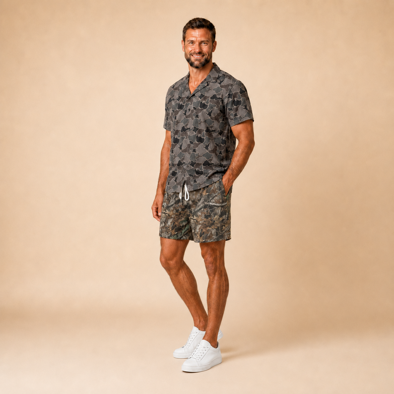 Man wearing Silpaz duck camo sport shorts in Dark Green Camo with a dark camp shirt, full length front view