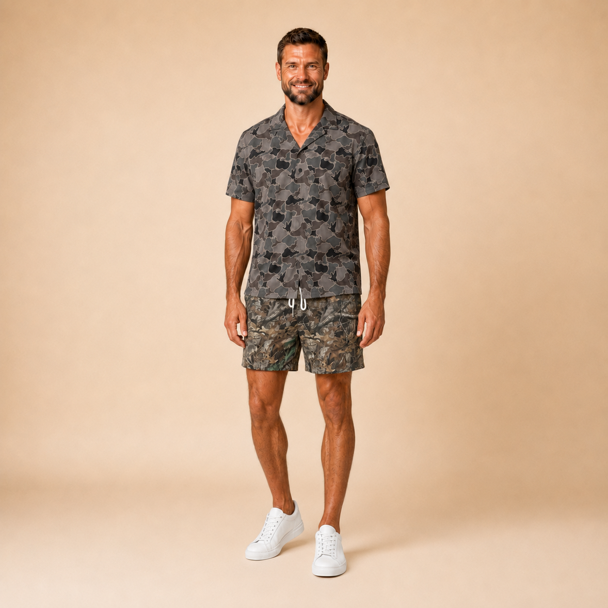 Man wearing Silpaz duck camo sport shorts in dark green camo, standing front view