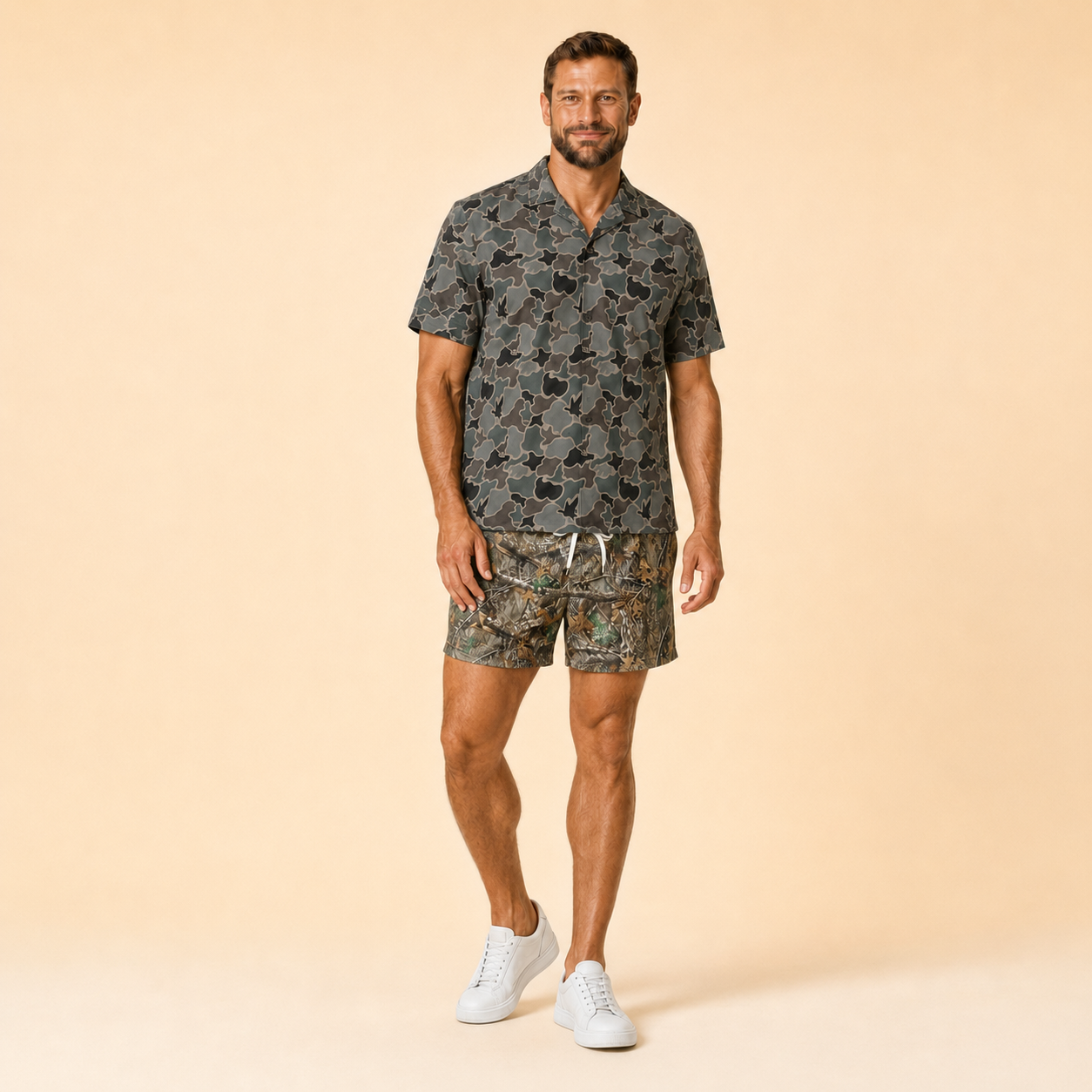 Man wearing Silpaz realistic camo mesh shorts with a dark camp shirt, full length three-quarter view