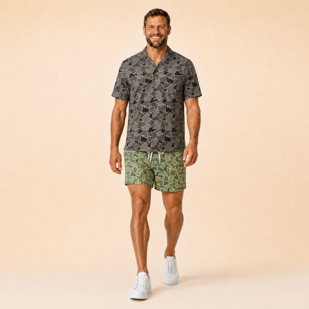 Man wearing Silpaz duck camo athletic shorts in sage green camo with a dark camp shirt, walking pose
